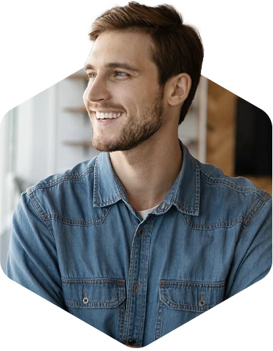Smiling young professional in a denim shirt looking confident in a modern office setting